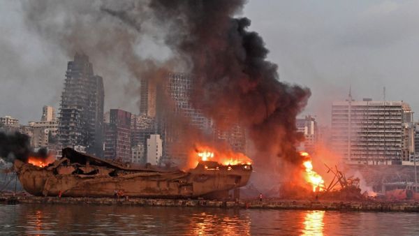 A ship is pictured engulfed in flames at the port of Beirut following a massive explosion that hit the heart of the Lebanese capital on August 4, 2020. Rescuers searched for survivors in Beirut on August 5 after a cataclysmic explosion at the port sowed devastation across entire neighbourhoods, killing more than 100 people, wounding thousands and plunging Lebanon deeper into crisis. AFP