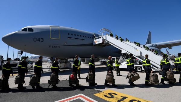 French Securite Civile (Civil Security) personnel board a Airbus A330, at Roissy airport, near Paris, on August 5, 2020. Bertrand GUAY / POOL / AFP