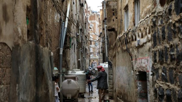 A Yemeni man stands in a flooded area following heavy rain fall on August 5, 2020 in the old city of the Yemeni capital Sanaa. The fierce storms have added to the woes of the war-torn country, which the UN has described as the world's worst humanitarian crisis. Five years of conflict has left swathes of the country in ruins. MOHAMMED HUWAIS / AFP