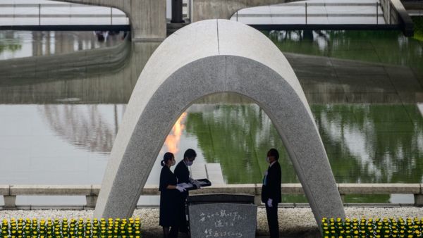 Hiroshima mayor Kazumi Matsui (R) and representatives of bereaved families take part in a ceremony at the Memorial Cenotaph during the 75th anniversary memorial service for atomic bomb victims at the Peace Memorial Park in Hiroshima on August 6, 2020. Japan on August 6, 2020 marked 75 years since the world's first atomic bomb attack, with the COVID-19 coronavirus pandemic forcing a scaling back of annual ceremonies to commemorate the victims. Philip FONG / AFP