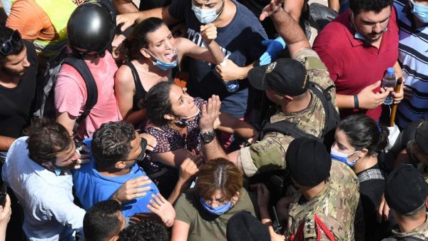 Lebanese anti-government protesters scuffle with security forces in the Gemayzeh neighbourhood during the visit of French President Emmanuel Macron on August 6, 2020, two days after a massive explosion in the Beirut port shook the capital. The blast caused massive destruction and killed at least 113 people, heaping misery on a country in crisis. AFP