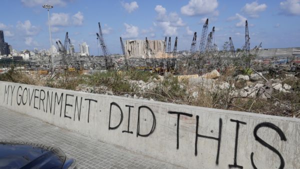A picture taken on August 9, 2020, shows graffiti on the wall of a bridge overlooking the port of Beirut, the site of the explosion which killed at least 154 people and devastated swathes of the capital. ANWAR AMRO / AFP