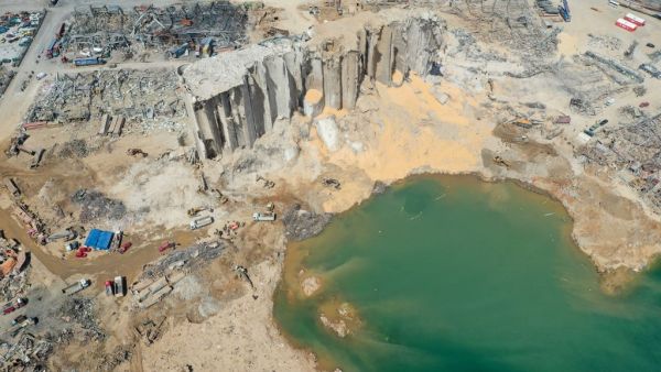 An aerial view taken on August 9, 2020, shows a general view of the port of Beirut, the damaged grain silo and the crater caused by the colossal explosion of a huge pile of ammonium nitrate that had languished for years in a port warehouse, leaving scores of people dead or injured and causing devastation in the Lebanese capital. The huge chemical explosion that hit Beirut's port, devastating large parts of the Lebanese capital and claiming over 150 lives, left a 43-metre (141 foot) deep crater, a security o