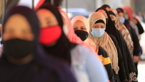Egyptians wearing face masks against Covid-19 queue up to vote on August 11, 2020 for a new senate in an upper house election. The two-day vote for 200 of the Senate's 300 seats will be largely contested by candidates who back President Abdel Fattah al-Sisi, who has quietened most opposition within and outside the legislature.  Khaled DESOUKI / AFP