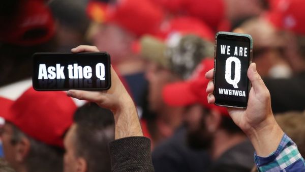 In this file photo taken on February 21, 2020 supporters of President Donald Trump hold up their phones with messages referring to the QAnon conspiracy theory at a campaign rally at Las Vegas Convention Center in Las Vegas, Nevada. (AFP)