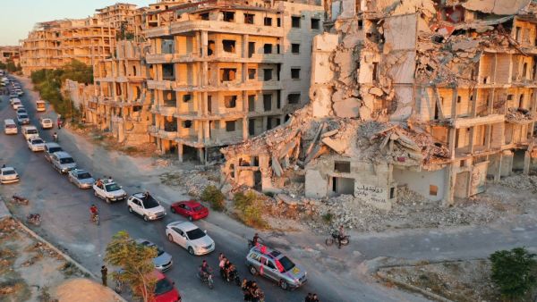 A wedding convoy drives along a road at the heavily damaged Jabal al-Arbain hiltop residential area, in the Syrian town of Ariha in the rebel-held northwestern Syrian Idlib province on August 14, 2020. Omar HAJ KADOUR / AFP