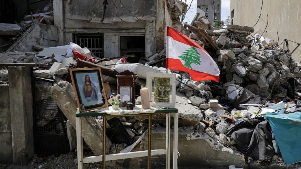 This picture taken on August 19, 2020 shows a make-shift Christian shrine with icons depicting Jesus Christ and the Virgin Mary, in memory of Claudette Yuhanna Saade, a Lebanese woman who was killed in the aftermath of the blast at the port of Beirut. JOSEPH EID / AFP