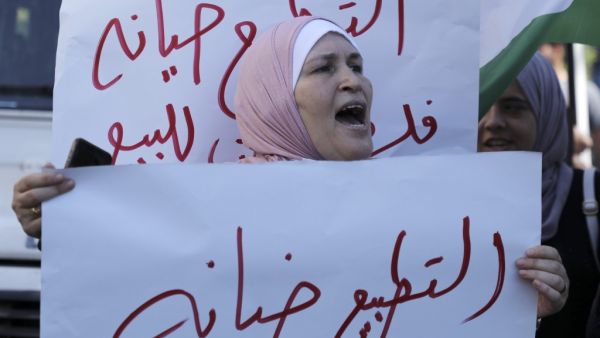 A Palestinian woman shouts slogans equating "normalisation with treachery" during a rally against the US-brokered UAE-Israel deal to normalise relations in the centre of the West Bank city of Nablus on August 26, 2020. (AFP)