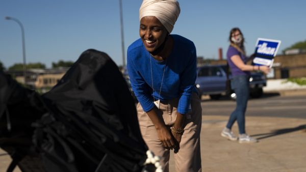 Rep. Ilhan Omar (D-MN) greets Isabel Aarts in her stroller during a campaign stop on August 11, 2020 in Minneapolis, Minnesota. (Stephen Maturen / GETTY IMAGES NORTH AMERICA / Getty Images via AFP)