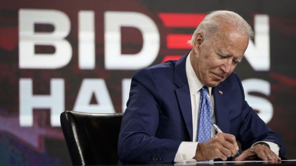 Presumptive Democratic presidential nominee former Vice President Joe Biden signs required documents for receiving the Democratic nomination for President at the Hotel DuPont on August 14, 2020 in Wilmington, Delaware. (AFP/File)