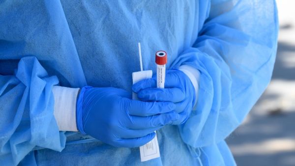 Mend Urgent Care workers wearing personal protective equipment perform drive-up COVID-19 testing at James Jordan Middle School on August 10, 2020 in Winnetka, California. The coronavirus pandemic spread quickly throughout the state, as California continues to lead the nation in number of cases. Kevin Winter/Getty Images/AFP KEVIN WINTER / GETTY IMAGES NORTH AMERICA / Getty Images via AFP