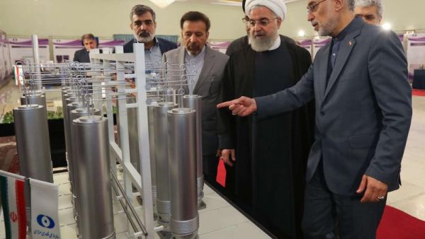 Iranian President Hassan Rouhani (2nd L) listening to head of Iran's nuclear technology organisation Ali Akbar Salehi (R) during the "nuclear technology day" in Tehran. (AFP)