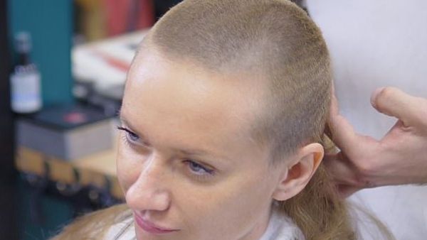 A file photo shows a woman having her long hair shaved off. The parents, uncle and aunt of a teenager of Bosnian Muslim origin will face trial in France on charges of violence against a minor for shaving her head because of her relationship with a Christian Serbian boy  (Shutterstock)