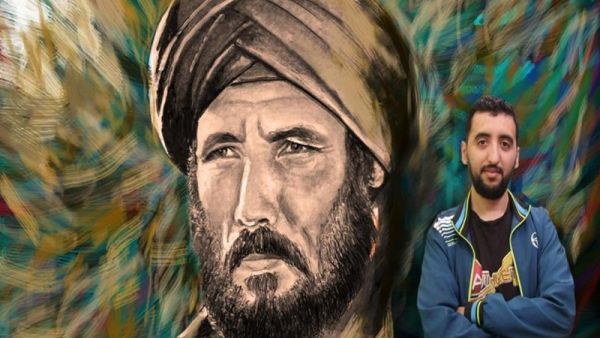 Shams El Din Belarbi in front of one of his hand-painted posters (Facebook)