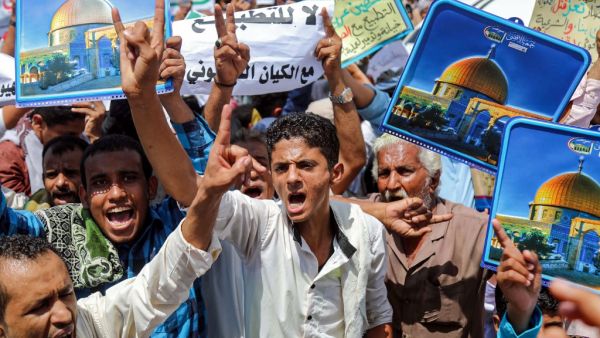 Demonstrators chant slogans with signs depicting Jerusalem's Dome of the Rock alongside other signs reading in Arabic "no to normalisation with the Zionist entity", during a protest in Yemen's third city of Taez on August 21, 2020. AHMAD AL-BASHA / AFP