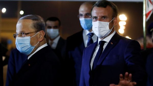 French President Emmanuel Macron (R) and Lebanese President Michel Aoun, both wearing face masks due to the Covid-19 pandemic, are pictured at Beirut International airport, on August 31, 2020. Macron arrived in Beirut for his second visit since a deadly explosion on August 4 shook the nation and fuelled a drive for political change. Macron, who first flew to Beirut only two days after the blast, arrived at 9 pm (1800 GMT) for a two-day visit that will include a ceremony marking the centenary of Greater Leba