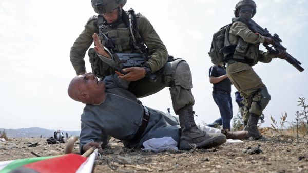 Israeli soldiers detain a Palestinian protester during a demonstration against the Israeli settlement expansion in the village of Jbara, south of Tulkarm in the occupied West Bank, on September 1, 2020. JAAFAR ASHTIYEH / AFP