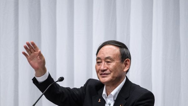Yoshihide Suga waves following a debate organized by Liberal Democratic Party, Youth Bureau, Women's Bureau at Liberal Democratic Party headquarters in Tokyo on September 9, 2020. Philip FONG / POOL / AFP