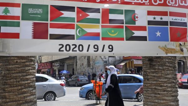 A banner showing the flags of Arab countries and reading "History will only glorify those loyal to Palestine" is seen during a rally against the UAE-Israel normalisation deal in the occupied West Bank city of Nablus on September 9, 2020, as Arab foreign ministers meet. JAAFAR ASHTIYEH / AFP
