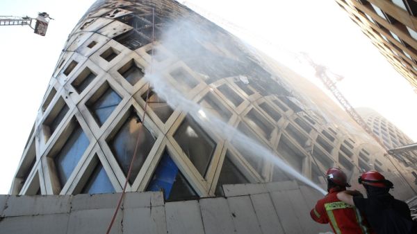 Lebanese firefighters douse the flames of a blaze that engulfed a landmark modern building, designed by the late world-renowned British-Iraqi architect Zaha Hadid, in central Beirut on September 15, 2020 The reasons behind the fire, which comes one week after another one at a Beirut port warehouse containing food, were not immediately known. ANWAR AMRO / AFP