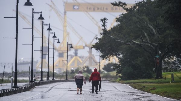 Residents walk on the costal road hours before Hurricane Sally makes landfall on the US Gulf Coast in Pascagoula, Mississippi on September 15, 2020. CHANDAN KHANNA / AFP
