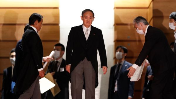 Japan's new Prime Minister Yoshihide Suga (C) leads his cabinet ministers for a photo session at prime minister's official residence in Tokyo on September 16, 2020. Yoshihide Suga became Japan's new prime minister on September 16, with the former chief cabinet secretary expected to stick closely to policies championed by Shinzo Abe during his record-breaking tenure. ISSEI KATO / POOL / AFP