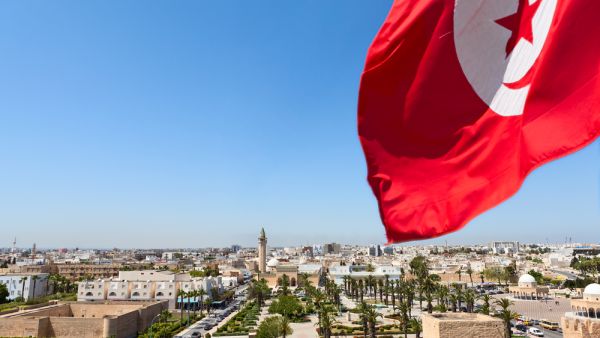 Top view of streets at Monastir city, Tunisia Minaret of mosque and Ribat as a fortress Red Tunisian flag  (Shutterstock)	