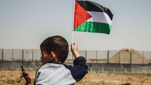 Small kid hold palestinian flag during the "Great March of Return" at the Israeil-Gaza border, on May15, 2019. (Shutterstock/ File Photo)