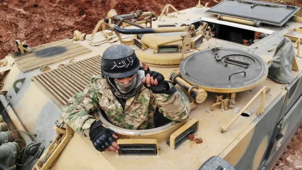 This file aerial photo taken on February 10, 2020 shows Turkish-backed Syrian fighters gathering in the village of Qaminas, about 6 kilometres southeast of Idlib city in northwestern Syria on February 10, 2020. Omar HAJ KADOUR / AFP