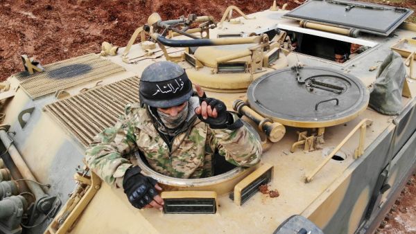 This file aerial photo taken on February 10, 2020 shows Turkish-backed Syrian fighters gathering in the village of Qaminas, about 6 kilometres southeast of Idlib city in northwestern Syria on February 10, 2020. Omar HAJ KADOUR / AFP