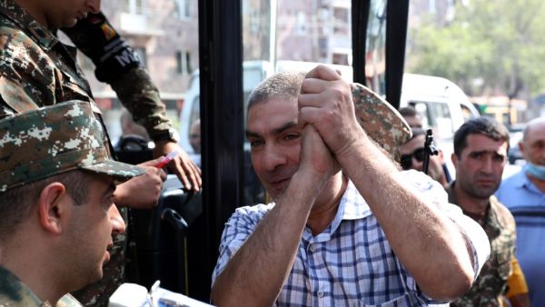 A man gestures boarding a bus to depart to the breakaway Nagorno-Karabakh region after Armenian authorities declared military mobilisation following armed clashes with Azerbaijan, Yerevan, September 28, 2020. Stepan Poghosyan / PHOTOLURE / AFP