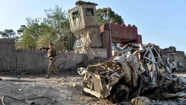 Security personnel inspect the site of a car bomb attack that targeted a government building in Ghani Khel district of Nangarhar province on October 3, 2020. At least 15 people were killed and more than 30 others wounded in a car bomb attack that targeted a government building in eastern Afghanistan on October 3, officials said.  NOORULLAH SHIRZADA / AFP