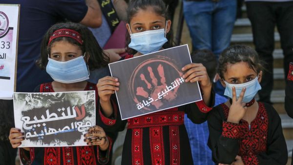 Palestinian children wearing face masks due to the Covid-19 pandemic attend a rally marking the 33rd anniversary of the Islamic Jihad group's founding, in Rafah, in the southern Gaza Strip, on October 6, 2020. SAID KHATIB / AFP