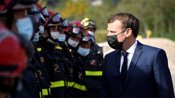 French President Emmanuel Macron (R) meets with members of the Civil Defence during a visit to Tende, in the Vallee de la Roya, some 50kms north-east of Nice, southeastern France, on October 7, 2020. (AFP/File Photo)