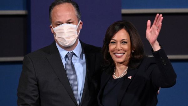 US Democratic vice presidential nominee and Senator from California, Kamala Harris (R) and husband Doug Emhoff stand onstage after the vice presidential debate in Kingsbury Hall at the University of Utah on October 7, 2020, in Salt Lake City, Utah. Robyn Beck / AFP