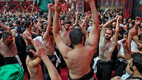 Shiite Muslim men take part in a mourning ritual in Iraq's central holy city of Karbala, on October 8, 2020, a day ahead of Arbaeen, which marks the end of the 40-day mourning period for the seventh century killing of Imam Hussein, Prophet Mohammed's grandson. Mohammed SAWAF / AFP