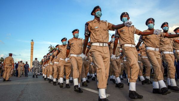 Security forces of Libya's UN-recognised Government of National Accord (GNA) march while mask-clad (COVID-19 coronavirus pandemic precaution) during an official parade commemorating "Police Day" at the Martyrs' Square in the GNA-held capital Tripoli on October 8, 2020. Mahmud TURKIA / AFP