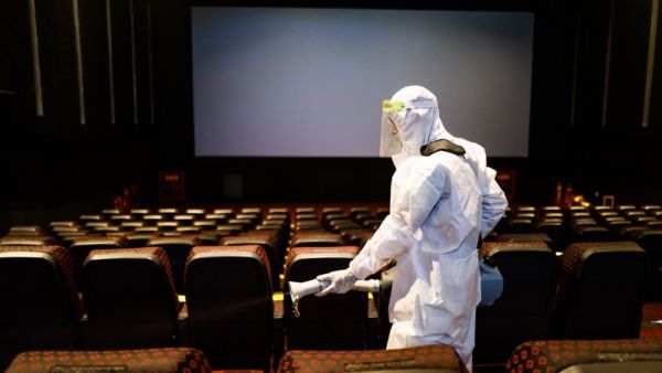 A worker sanities inside a theatre hall ahead of the scheduled reopening of cinema theatres on October 15 as the Covid-19 coronavirus imposed lockdown eases further in New Delhi on October 13, 2020. Jewel SAMAD / AFP