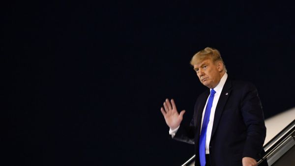 US President Donald Trump waves as he steps off Air Force One upon arrival at McCarran International Airport in Las Vegas, Nevada on October 18, 2020. MANDEL NGAN / AFP
