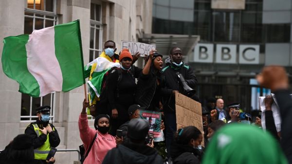 Protestors shout slogans during a protest action against police brutality in Nigeria, outside the BBC offices in central London on October 24, 2020. UN Secretary General Antonio Guterres has called for an end to what he called "brutality" by police in Nigeria, which has been rocked by two weeks of protests. Guterres said gunmen that opened fire on peaceful protesters Tuesday evening in Lagos caused "multiple deaths" and many injuries. DANIEL LEAL-OLIVAS / AFP