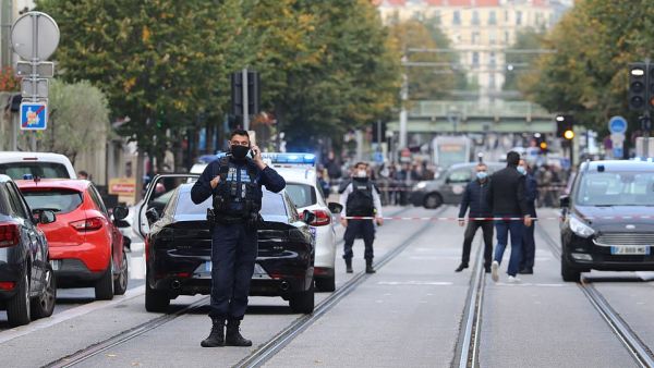 French policemen stand guard a street after a knife attack in Nice. (AFP)