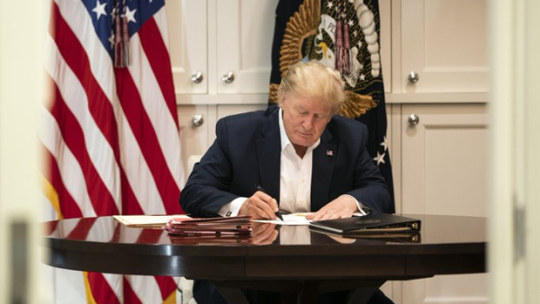 Donald Trump was photographed at Walter Reed Medical Center appearing to sign a blank piece of paper in an attempt to show he was still working. (Twitter)