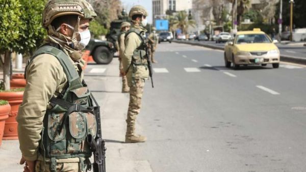Jordanian army soldiers deployed at entrances and exits of main cities to enforce COVID-19 confinement measures. (AFP)