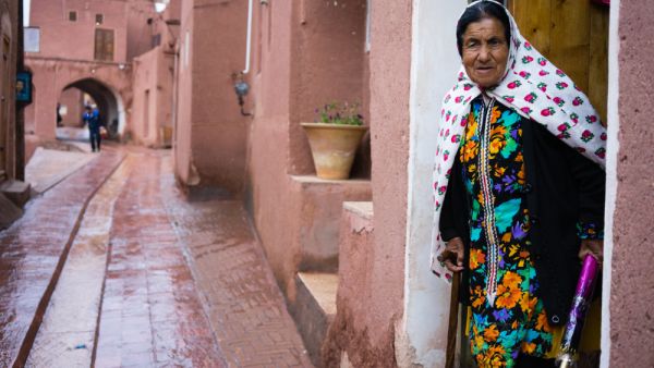 lady in traditional clothes in the ancient village of Abyaneh, near Kashan, in Iran. In background, the typical red mud-brick houses of Abyaneh  (Shutterstock)	