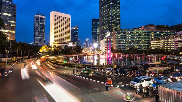 Traffic around Plaza Indonesia in Jakarta business district at night in Indonesia capital city.  (Shutterstock)	