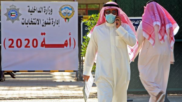 A candidate for the upcoming Kuwaiti parliamentary election talks on the phone at the Department of Elections in Kuwait City on the first day of candidate registration, on October 26, 2020. YASSER AL-ZAYYAT / AFP 