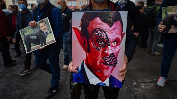 People hold caricatures of French President Emmanuel Macron during a demonstration on October 30, 2020 in Istanbul amid anger in the Islamic world over French President's defence of the right to publish cartoons seen as offencive to Islam. Yasin AKGUL / AFP