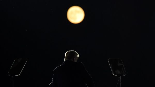 US President Donald Trump speaks as a full moon rises during a rally at Pittsburgh-Butler Regional Airport in Butler, Pennsylvania on October 31, 2020. MANDEL NGAN / AFP
