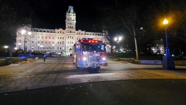 A firefighter truck is parked in front of the National Assembly of Quebec, in Quebec City, early on November 1, 2020, after two people were killed and five wounded by a sword-wielding suspect dressed in medieval clothing. (AFP)