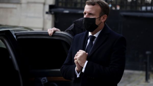 French President Emmanuel Macron greets Austrian ambassador Michael Linhart (not pictured) who has gone into self-isolation after coming into contact with a person who has tested positive for COVID-19, after signing a condolence book for victims of the Vienna attack in Paris, on November 3, 2020. Four persons are reported to have died and many are seriously injured in what officials treat as a terror attack which took place in the evening of November 2 in Vienna. Christophe PETIT TESSON / POOL / AFP